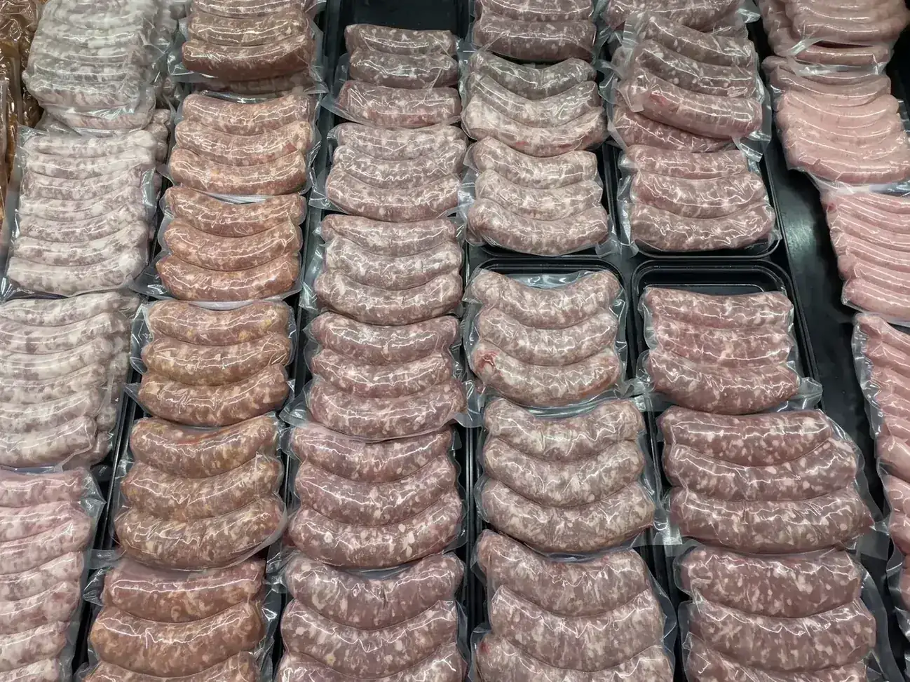 Rows of house-made sausage links in the Plymouth Prime Meats case
